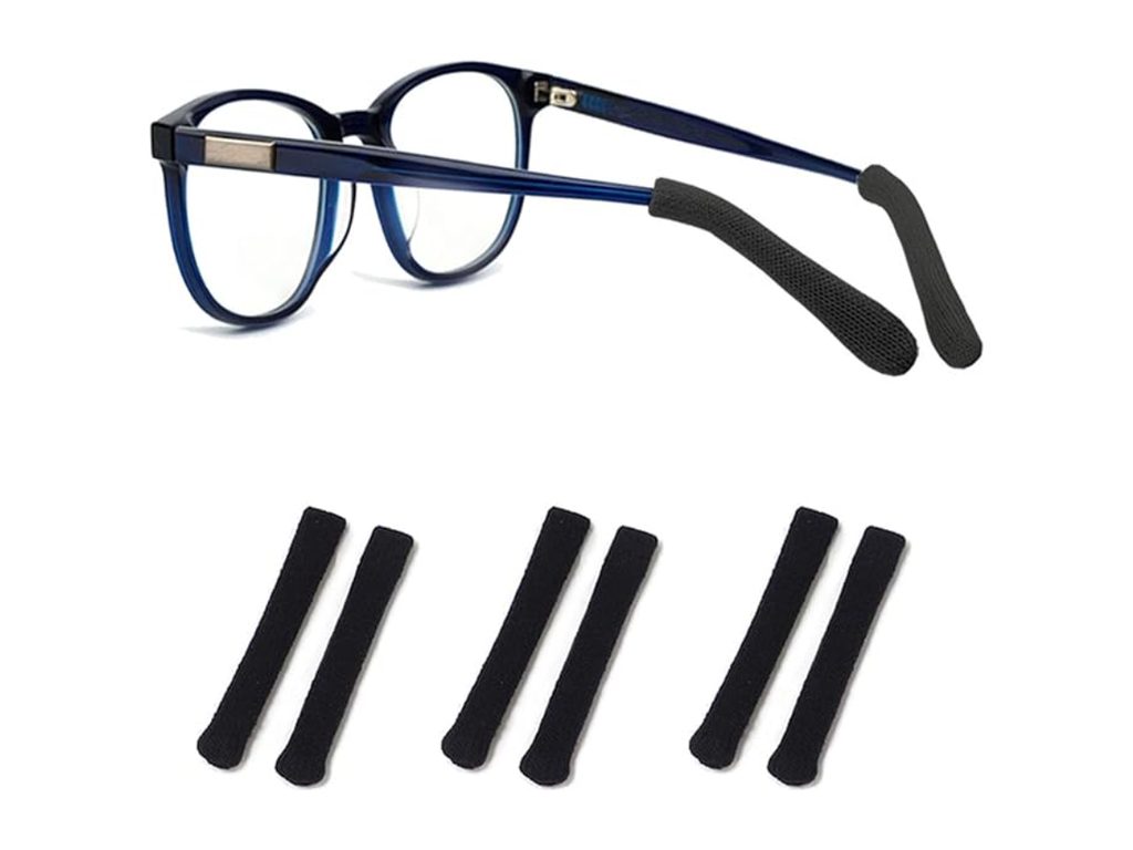 Three pairs of black knit-textured grips that slide over the ends of glasses temples, shown with a pair of glasses